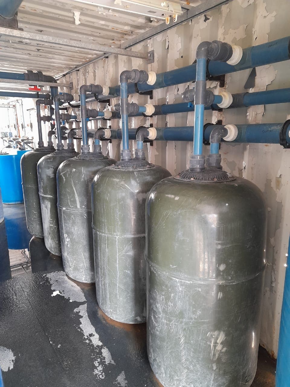 A row of filtration vessels connected inside a packaged treatment plant