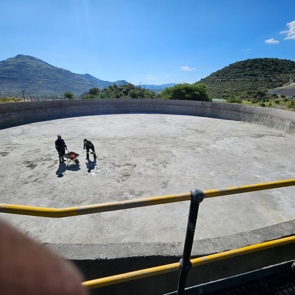 Technicians carrying out maintenance inside a large water reservoir