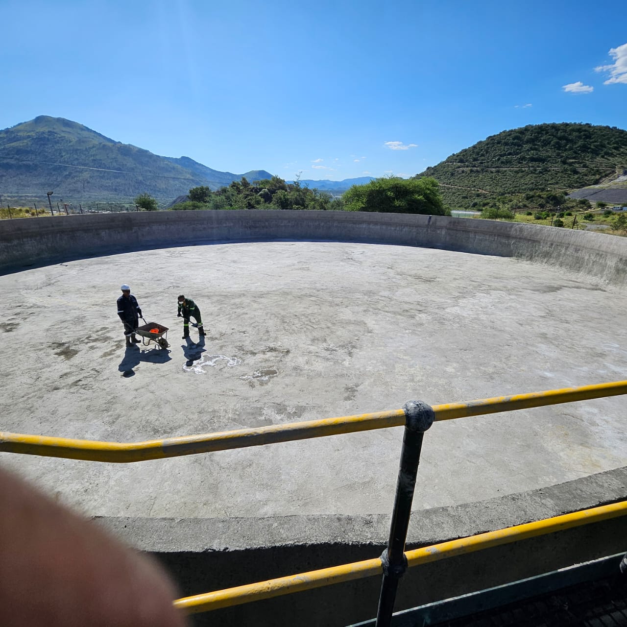 Mthumbi personnel working inside a treatment reservoir