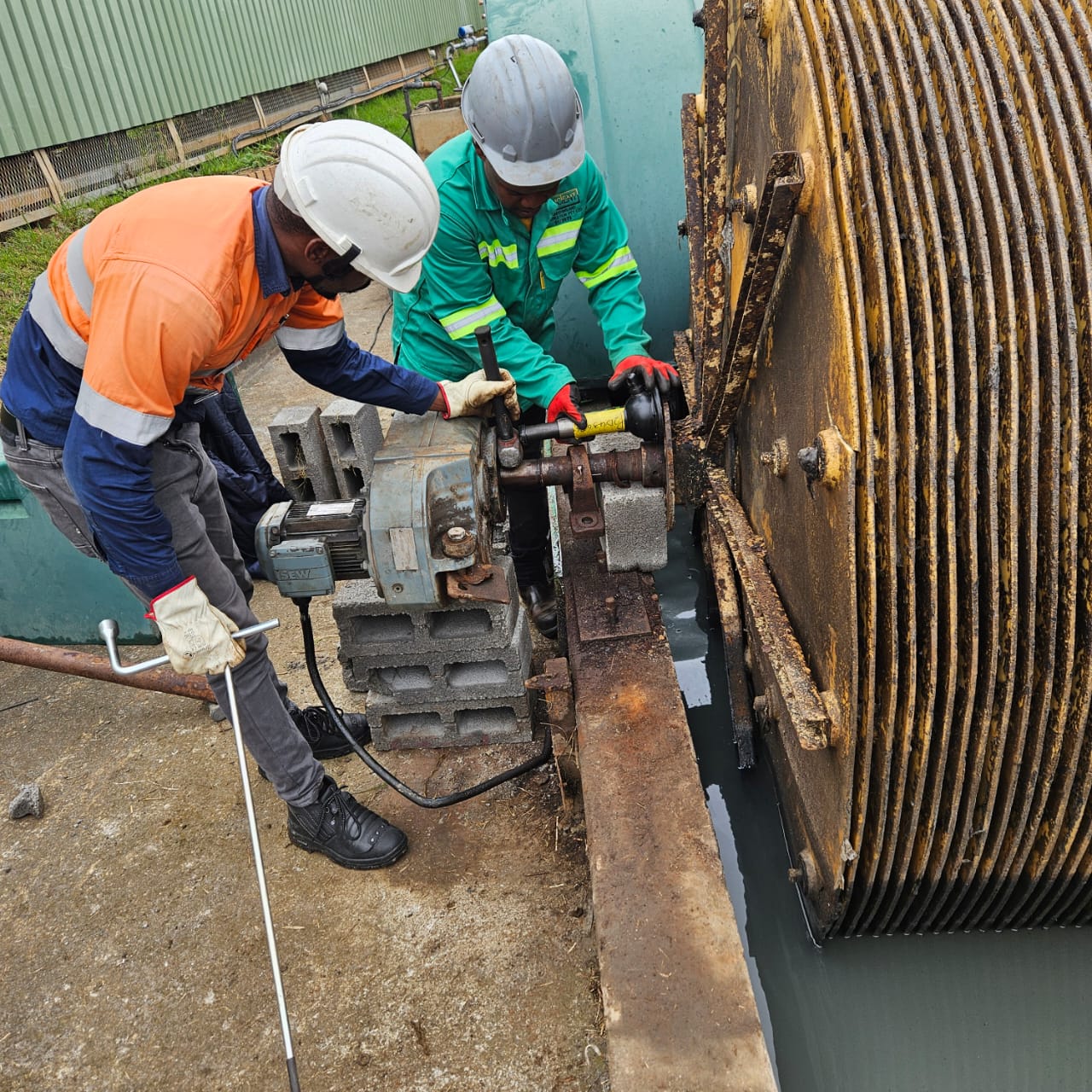 Technicians carrying out maintenance on water-treatment equipment